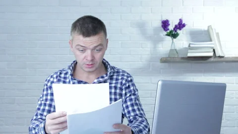 Young businessman working with documents, sitting at office desk. Stock Footage 99441660