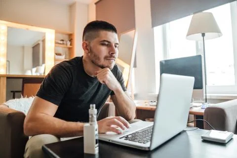 Young businessman working in front of computer in office - freelance concept. Stock Photos
