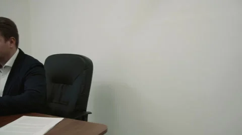 Young businessman working in his office in front of the laptop computer then he Stock Footage