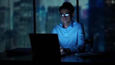 Young businessman working at the office with panoramic city view at night Stock-Footage 93233363