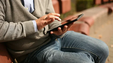 Young businessman working on tablet computer in city park, 1080p Stock Footage 28505097