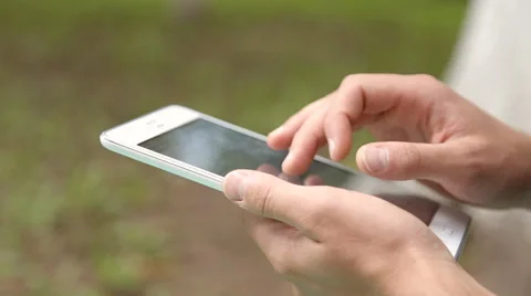 Young businessman working on tablet computer in the park Stock Footage 67880987