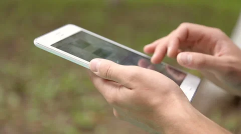 Young businessman working on tablet computer in the park Stock Footage 67881024