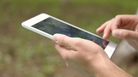 Young businessman working on tablet computer in the park Stock Footage 67881130