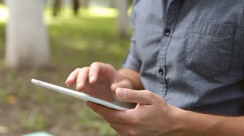 Young businessman working on tablet computer in the park Stock Footage 67881225