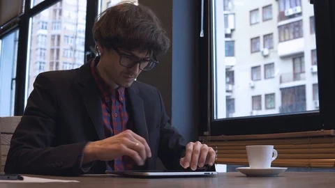 Young businessman working on a tablet  Stock Footage 86490908