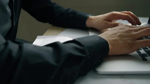 Young businessman working typing text, sitting at desk with laptop in modern Stock Footage 89963501