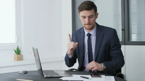Young businessman writing down a good idea on a piece of paper Stock Footage 68400687