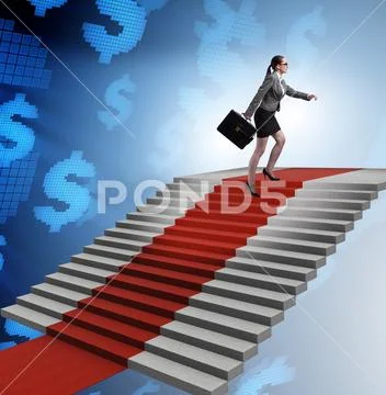 Young businesswoman climbing stairs and red carpet Stock Photos