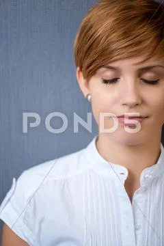 Young businesswoman with eyes closed Stock Photos