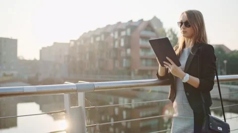 Young Businesswoman Using Digital Tablet in Sunny City. SLOW MOTION STEADICAM Stock Footage