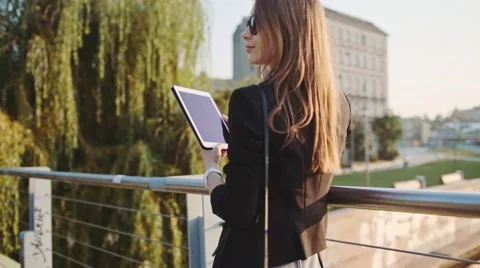 Young Businesswoman Using Digital Tablet in Sunny City. SLOW MOTION STEADICAM Stock Footage