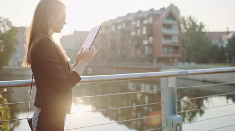 Young Businesswoman Using Digital Tablet in Sunny City. SLOW MOTION STEADICAM Stock Footage