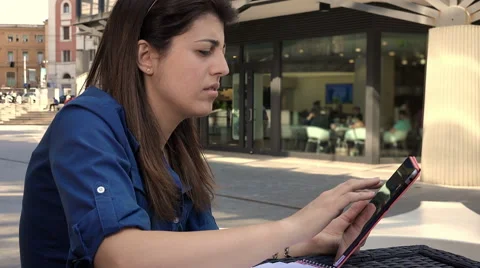 Young businesswoman using tablet computer outdoor at the table of a cafe Video stock 66584494