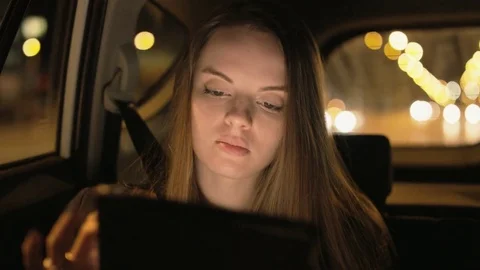 Young Businesswoman Using a Tablet Computer in the Car Stock Footage 75530017