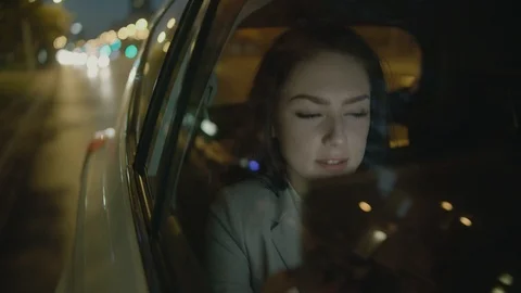Young Businesswoman Using a Tablet Computer in the Moving Car Stock Footage 97934771