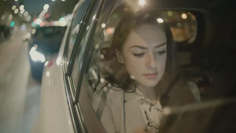 Young Businesswoman Using a Tablet Computer in the Moving Car Stock Footage 97940064
