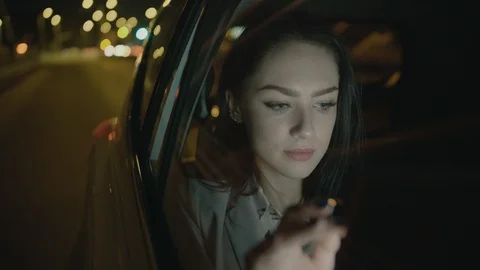 Young Businesswoman Using a Tablet Computer in the Moving Car Stock Footage 97953363