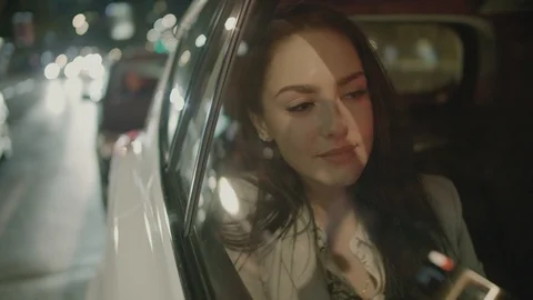 Young Businesswoman Using a Tablet Computer in the Moving Car Stock Footage 97957536
