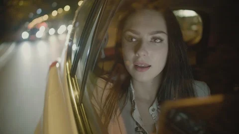 Young Businesswoman Using a Tablet Computer in the Moving Car Stock Footage 97993881