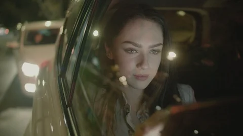 Young Businesswoman Using a Tablet Computer in the Moving Car Stock Footage 97995746