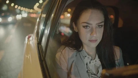 Young Businesswoman Using a Tablet Computer in the Moving Car Stock Footage 98030683