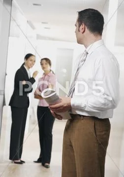 Young businesswoman whispering and businessman listnening Stock Photos