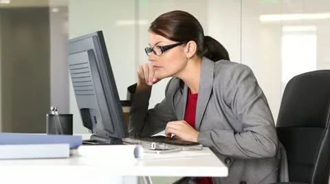 Young businesswoman working on computer at desk Stock Footage