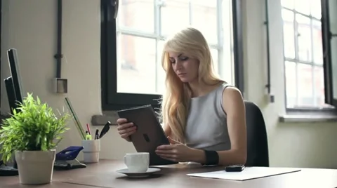 Young businesswoman working on tablet computer in office, dolly shot HD Stock Footage
