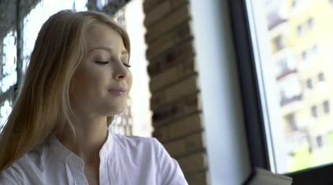 Young businesswoman working on tablet computer while drinking coffee in the Stock Footage 67648089