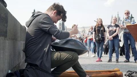 Young busker playing hand drum music on Charles Bridge in Prague, Czech Video stock 107792207