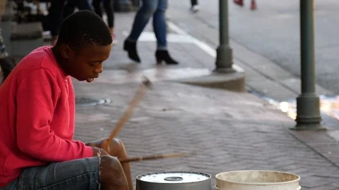 Young busker playing makeshift drums on a street Stock Footage 87109504