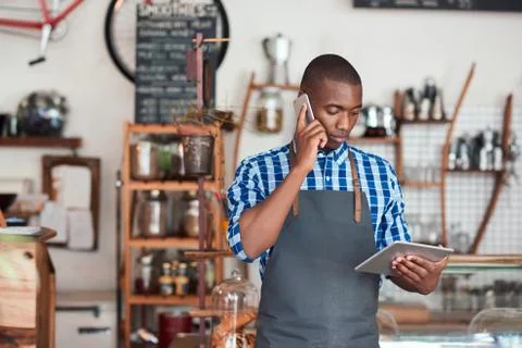 Young cafe owner hard at work in his trendy cafe Stock Photos