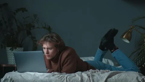 Young calm programmer is working at home at bed, freelance creating product Stock Footage 146309709