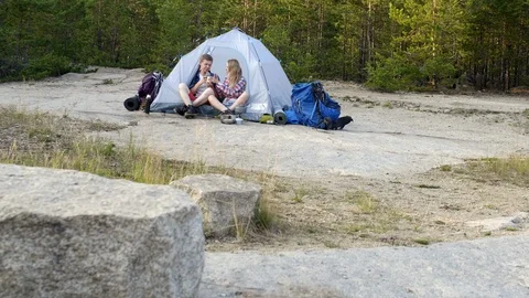 Young campers having launch in forest near tent Vidéo 118548924