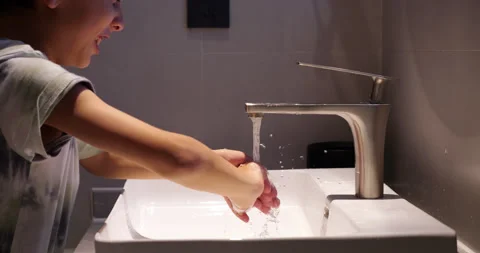 Young capricious boy quickly wash hands with grin on his face Stock-Footage 322043823