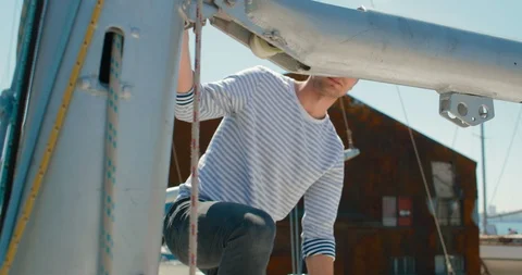 The young captain checks the sling lines on his sailing yacht Stock Footage 89173993