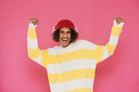Young caribbean man dancing while listening music with headphones Stock Photos