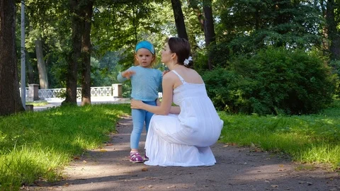 Young caring mother communicates with her charming little daughter Stock Footage 115959995