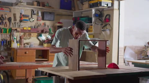 Young carpenter apprentice working at woodwork business. One black Brazilia.. Stock Footage 246846516
