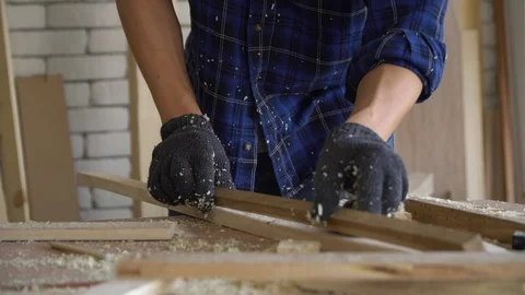 A young carpenter is choosing and measuring the length of the wood. 動画素材 125563757