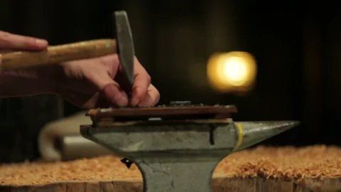 Young carpenter hammers a flat bracket on some boards of wood Stock-Footage 100982138