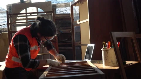 Young carpenter man using sandpaper on a piece of wood in workshop . Stock Footage 158424513