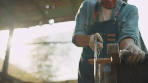 Young carpenter man using a saw to cuting timber during woodworking in workplace Stock Footage 264282859