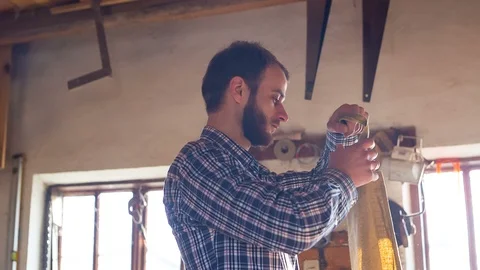 Young carpenter started its own business in the garage Stock Footage 89651846