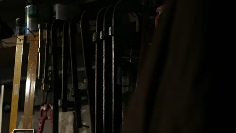 Young carpenter takes two clamps from the wall Stock-Footage 100761085