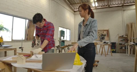 Young carpenter teamwork man and woman building design wood house Video stock 126450936