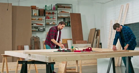 Young carpenters build a solid wood wall in a carpentry workshop. Stock Footage 144089900