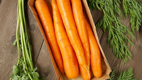 Young carrots on the table. Video stock 302920496