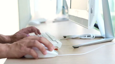 Young casual asian man using desktop computer at light and modern office space Stock Footage 62228882